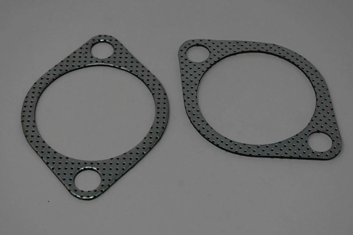 Two 3-inch downpipe to exhaust gaskets for Subaru WRX STI, EVO X, and Legacy, by Jack Spania Racing, showing gasket details.