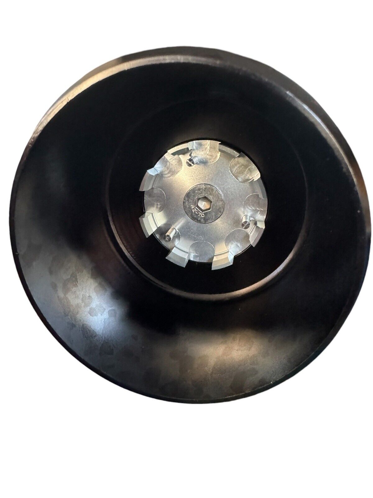 Billet oil filter housing cap for BMW N54, N55, S55 engines from JackSpania Racing, shown on engine part.