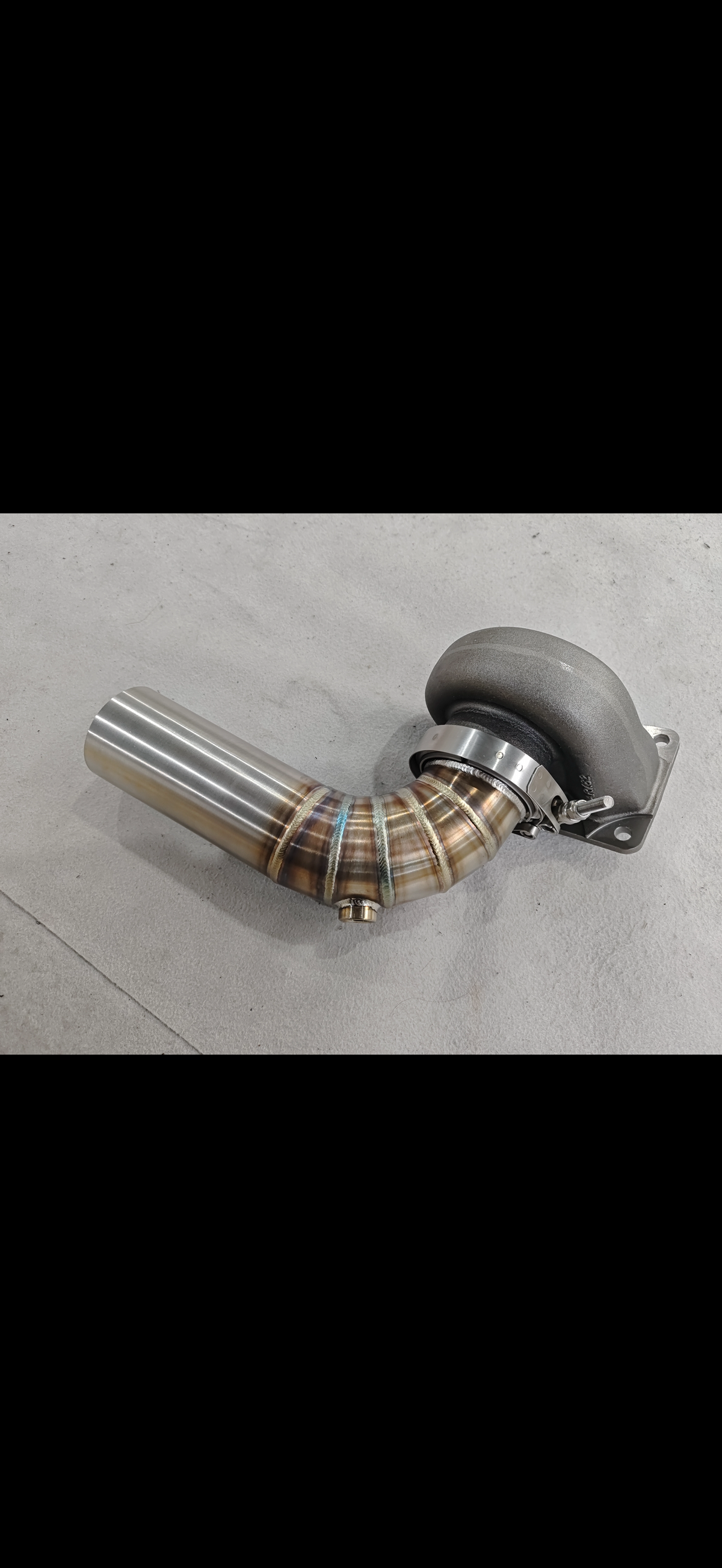 JackSpania Racing 3-inch downpipe with V-band flange and O2 bung, designed for Garrett Holset and BorgWarner turbo exhaust systems.