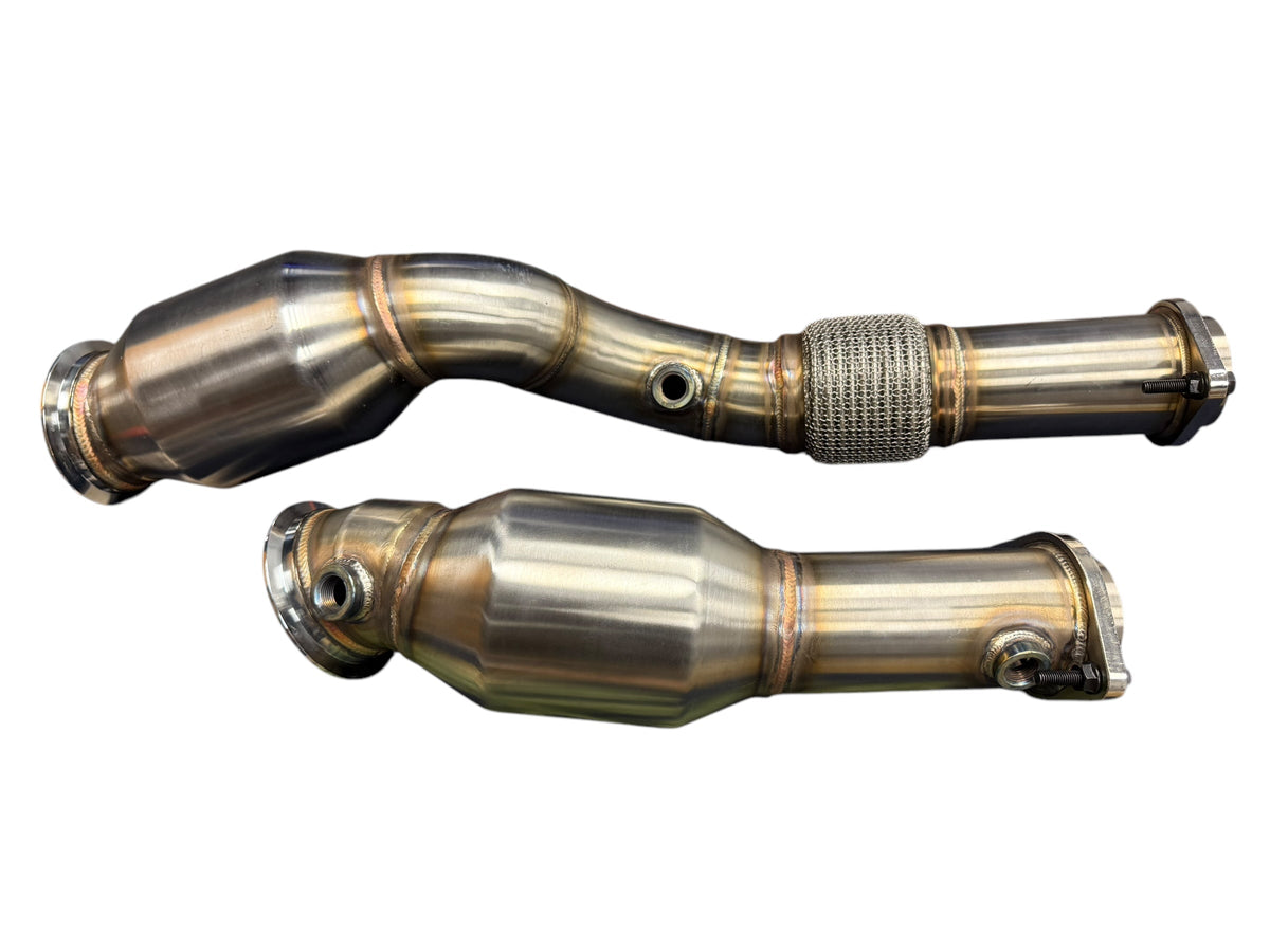 High flow downpipes with cats for BMW S58 M2 G80 M3 G82 M4 G87 by JackSpania Racing, showing polished exhaust components.