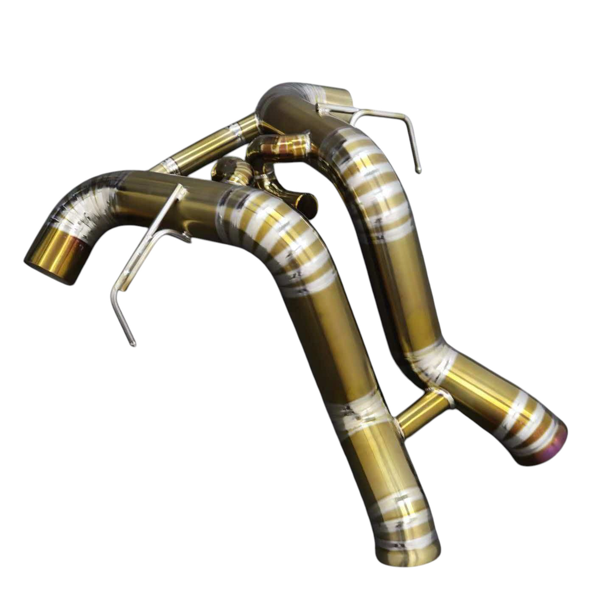 JackSpania Racing titanium exhaust system for McLaren 570S, 620R, and 540C F1 race cars, showing polished metal pipes and fittings.