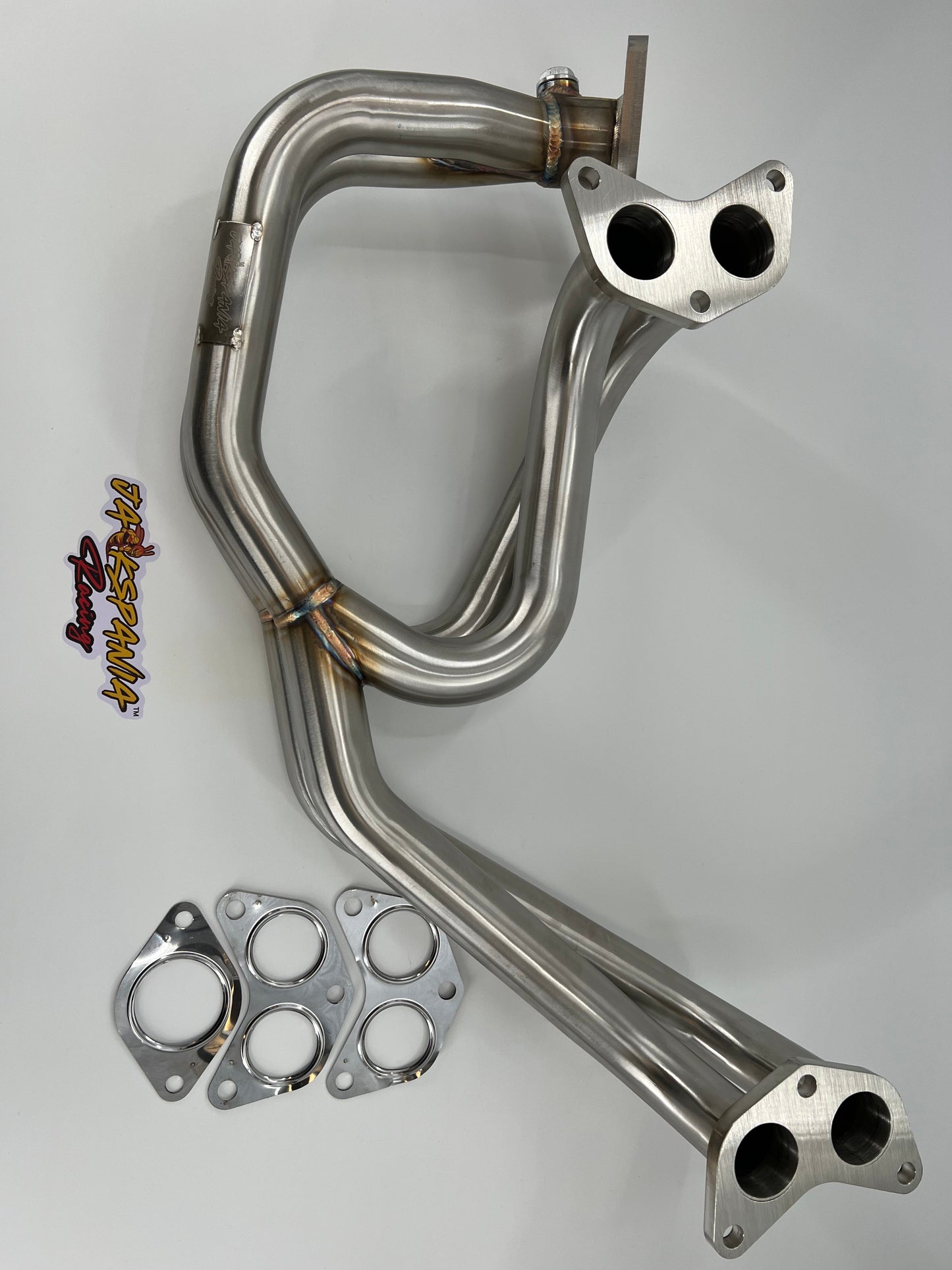 Subaru WRX and STi EJ25 equal length exhaust manifold header by JackSpania Racing, showing polished metal construction.