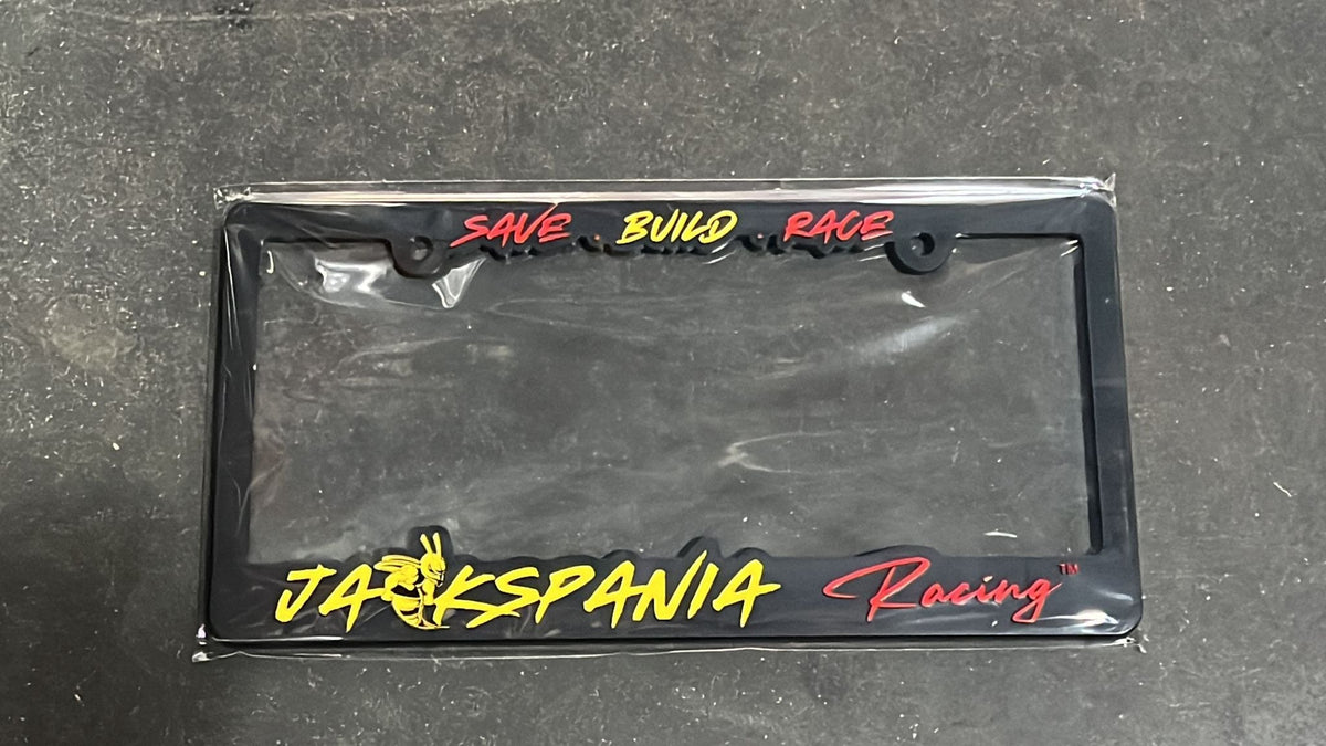 JackSpania Racing license plate cover with bold black and white design, featuring racing logo and sleek finish for vehicle decoration.