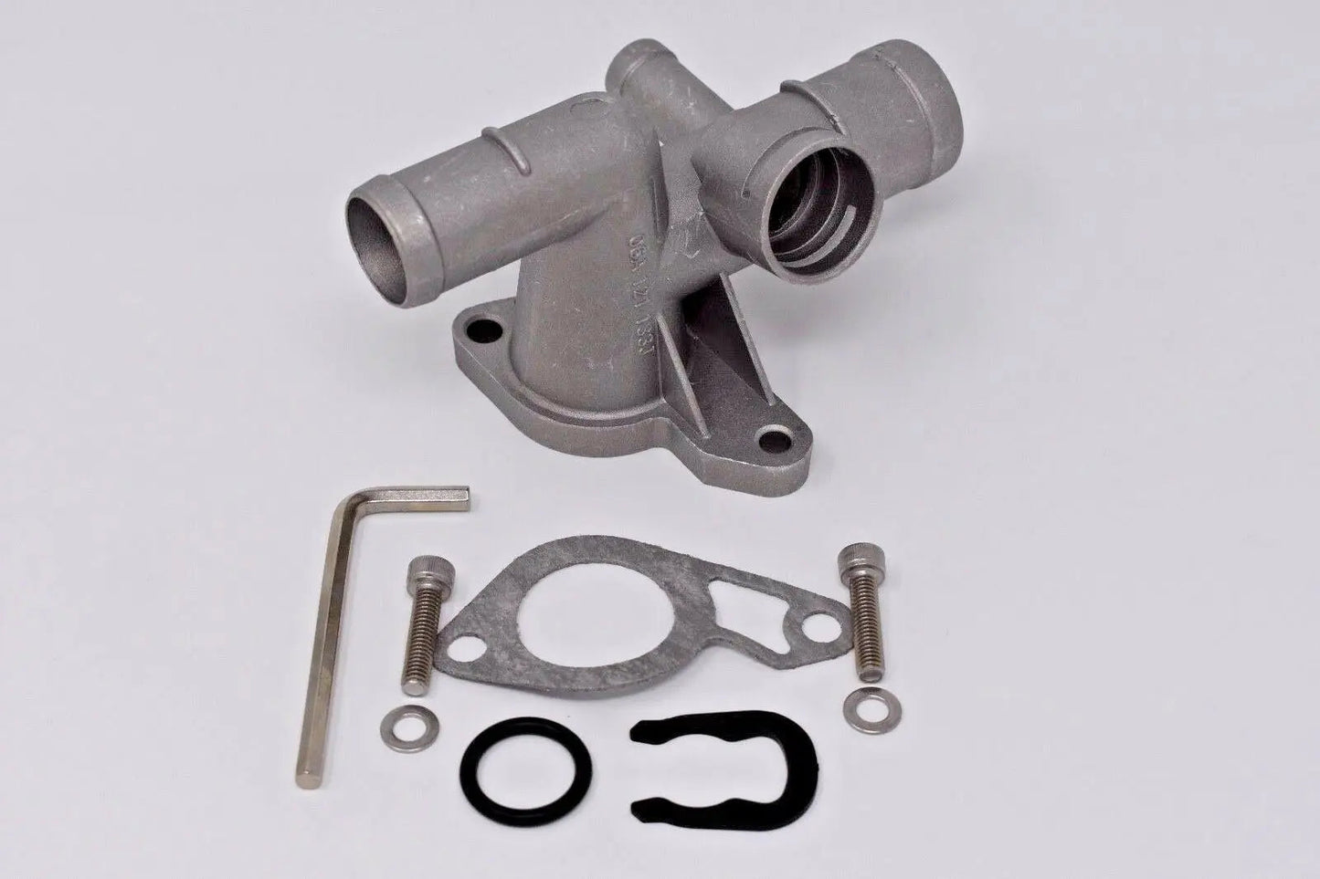 VW MK4 Golf Jetta GTI GLI TT 1.8T engine coolant cast flange by Jack Spania Racing, showing the metal component with mounting points.