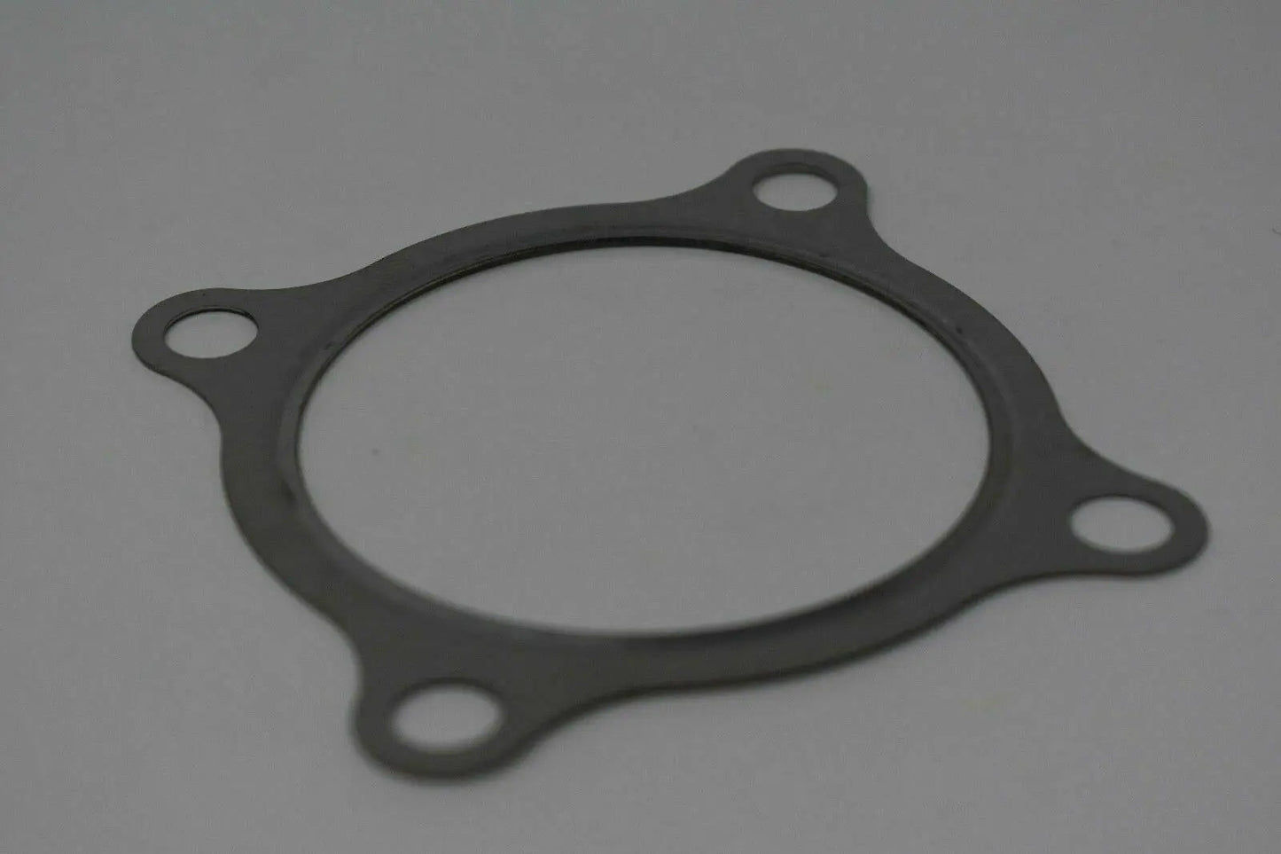 Stainless steel 3-inch turbo downpipe gasket for GT30 GT35 T3 T2 T4 T6 turbos, by Jack Spania Racing, showing the gasket and flange.