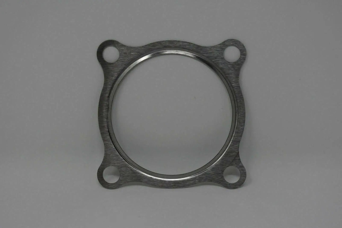 Stainless steel gasket for 3-inch turbo downpipe, fits GT30 and GT35 T3 turbochargers, by Jack Spania Racing.
