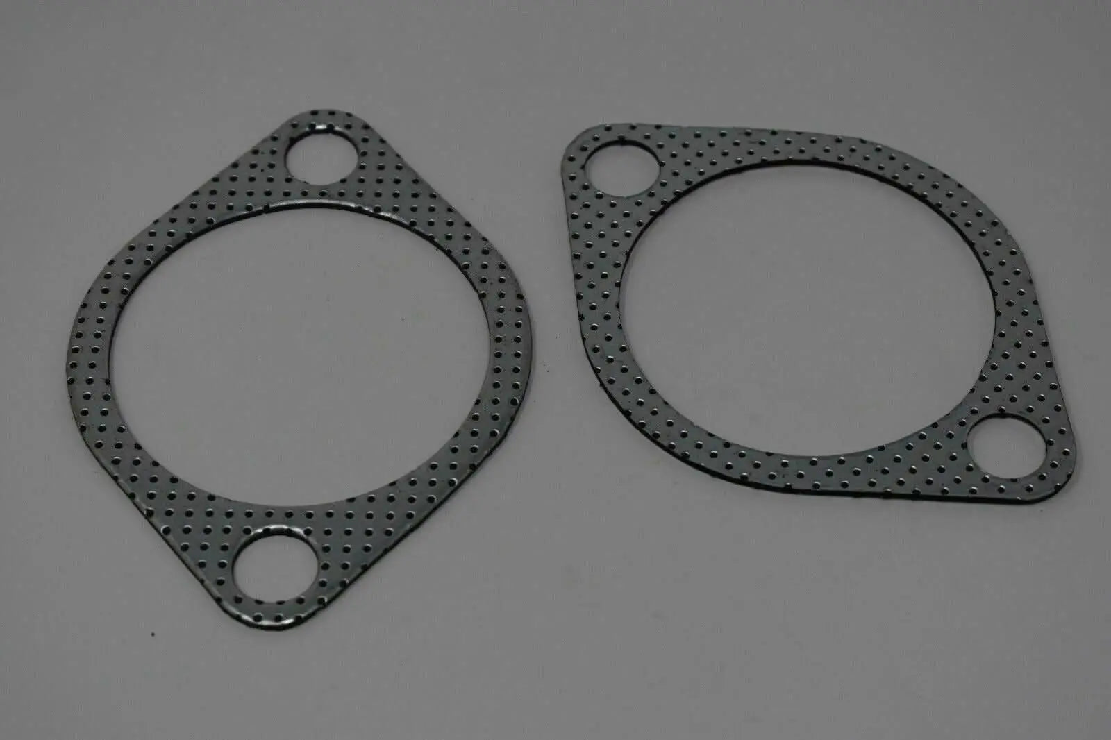 Two 3-inch downpipe to exhaust gaskets for Subaru WRX STI, EVO X, and Legacy, by Jack Spania Racing, showing gasket details.