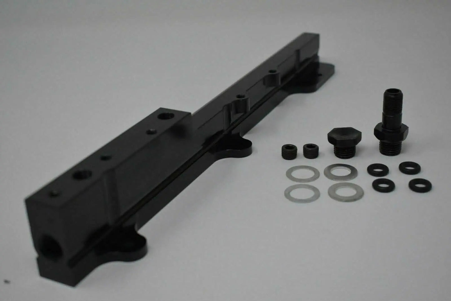 High-flow B Series fuel rail for Honda Acura engines, from Jack Spania Racing, featuring metal construction and inlet ports.