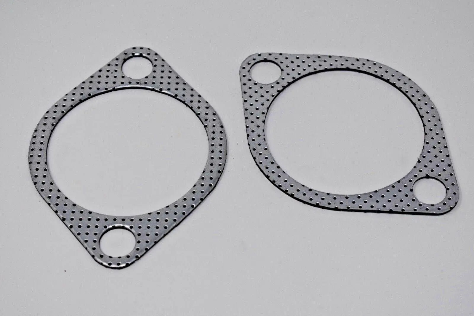 Two 2.5-inch downpipe-to-exhaust gaskets for Subaru WRX STI EVO X 10 GT, made by Jack Spania Racing, with bolt holes for engine installation.