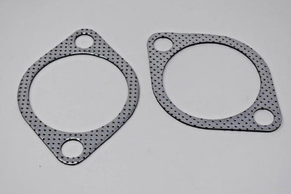 Two 2.5-inch downpipe-to-exhaust gaskets for Subaru WRX STI EVO X 10 GT, made by Jack Spania Racing, with bolt holes for engine installation.