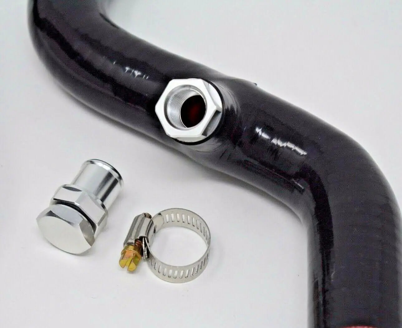 Jack Spania Racing K- Swap driver side radiator hose kit with fan hose bung for K20, EG, EK, DC2, and CRX Si engine applications.