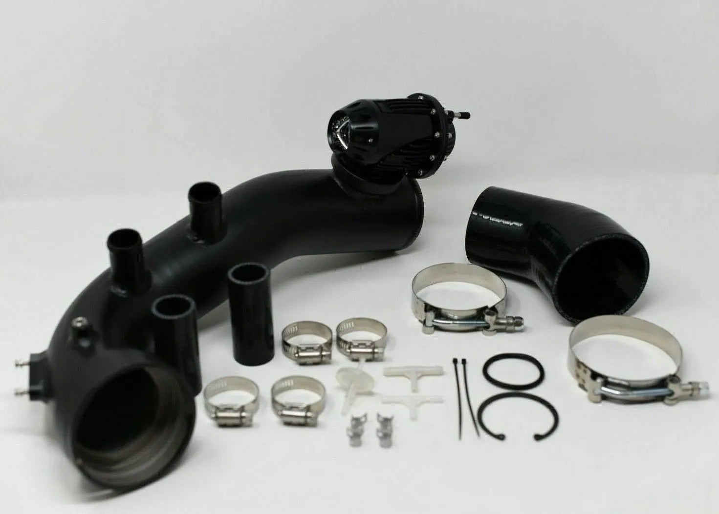 BMW N54 charge pipe kit with SSQV blow off valve for E88 E90 E92 E93 135i 335i turbo engine, installed on a turbo engine setup.