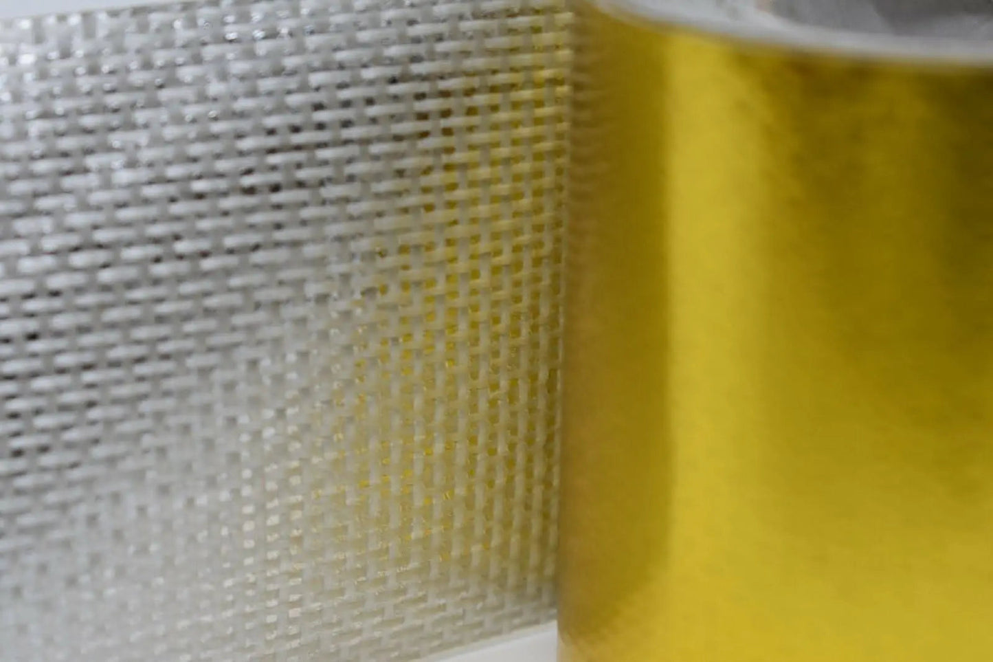 Giant gold reflective thermal heat shield tape roll for turbo engine parts by Jack Spania Racing, used for heat protection.