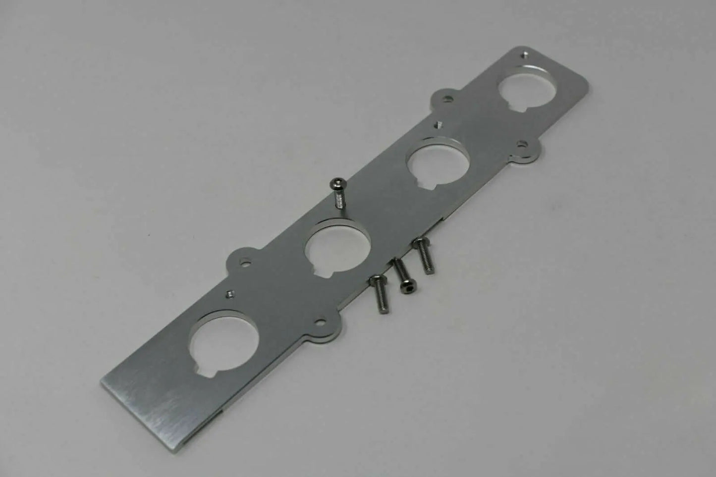 Jack Spania Racing B Series Coil On Plug (COP) Adapter Plate for Honda Acura B16 B18 engine conversion, showing the metal plate and mounting points.