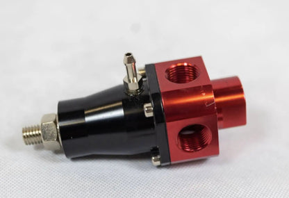 EFI adjustable fuel pressure regulator by Jack Spania Racing, 3-port billet aluminum FPR with 3-60 PSI, mounted on engine parts.