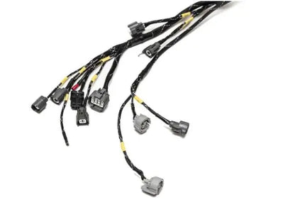 Jack Spania Racing B D H F Series tucked engine harness kit installed in a Honda Acura Prelude, showing wiring and connectors.