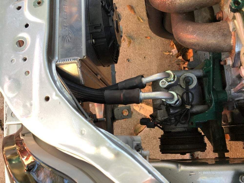 Jack Spania Racing D Series AC Line Tuck Kit installed in Honda Civic Si Acura Integra DC2 engine, showing the compact engine modification.