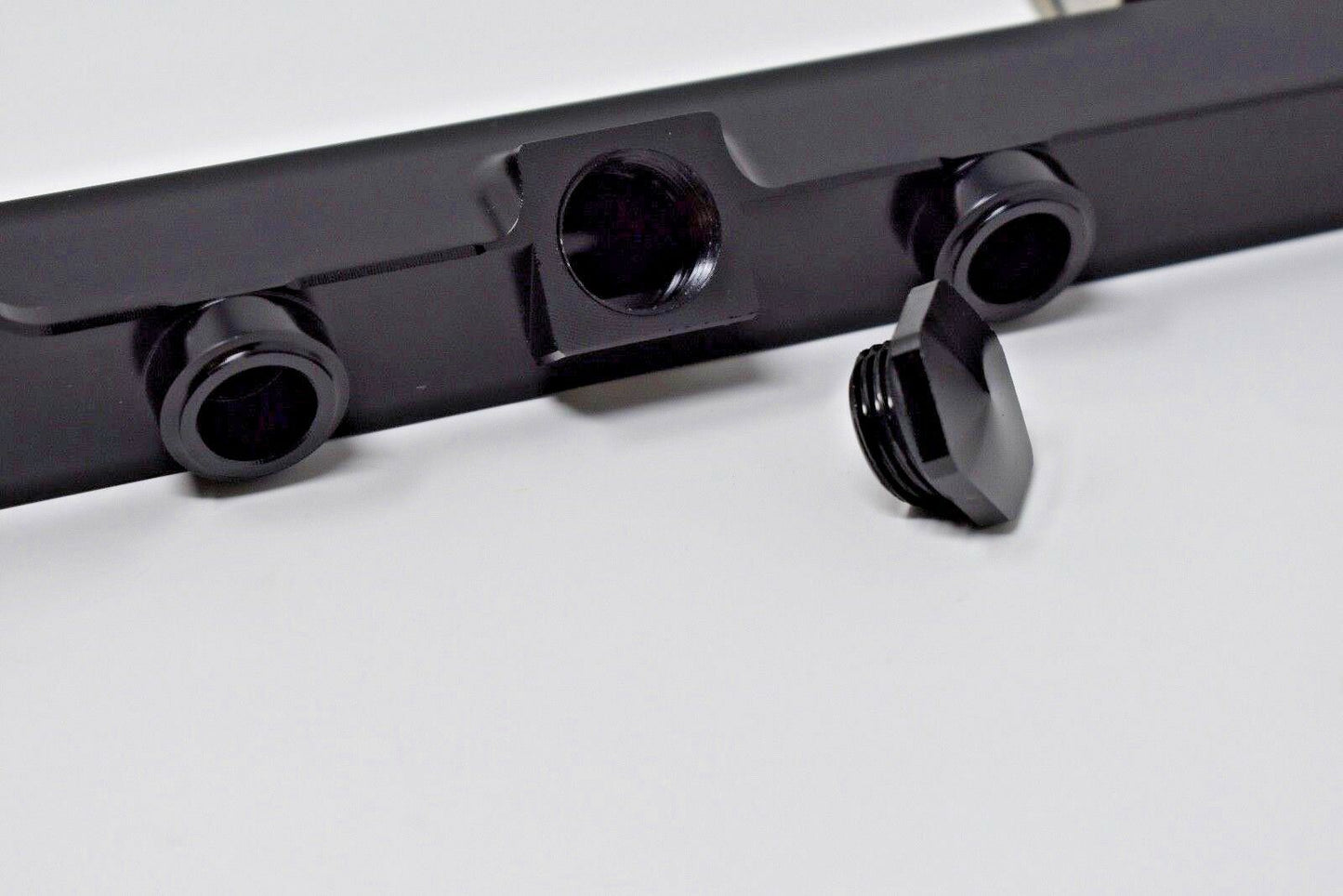 High flow K Series fuel rail for Honda Acura K20 K24 engines, made by Jack Spania Racing, shown on engine part.