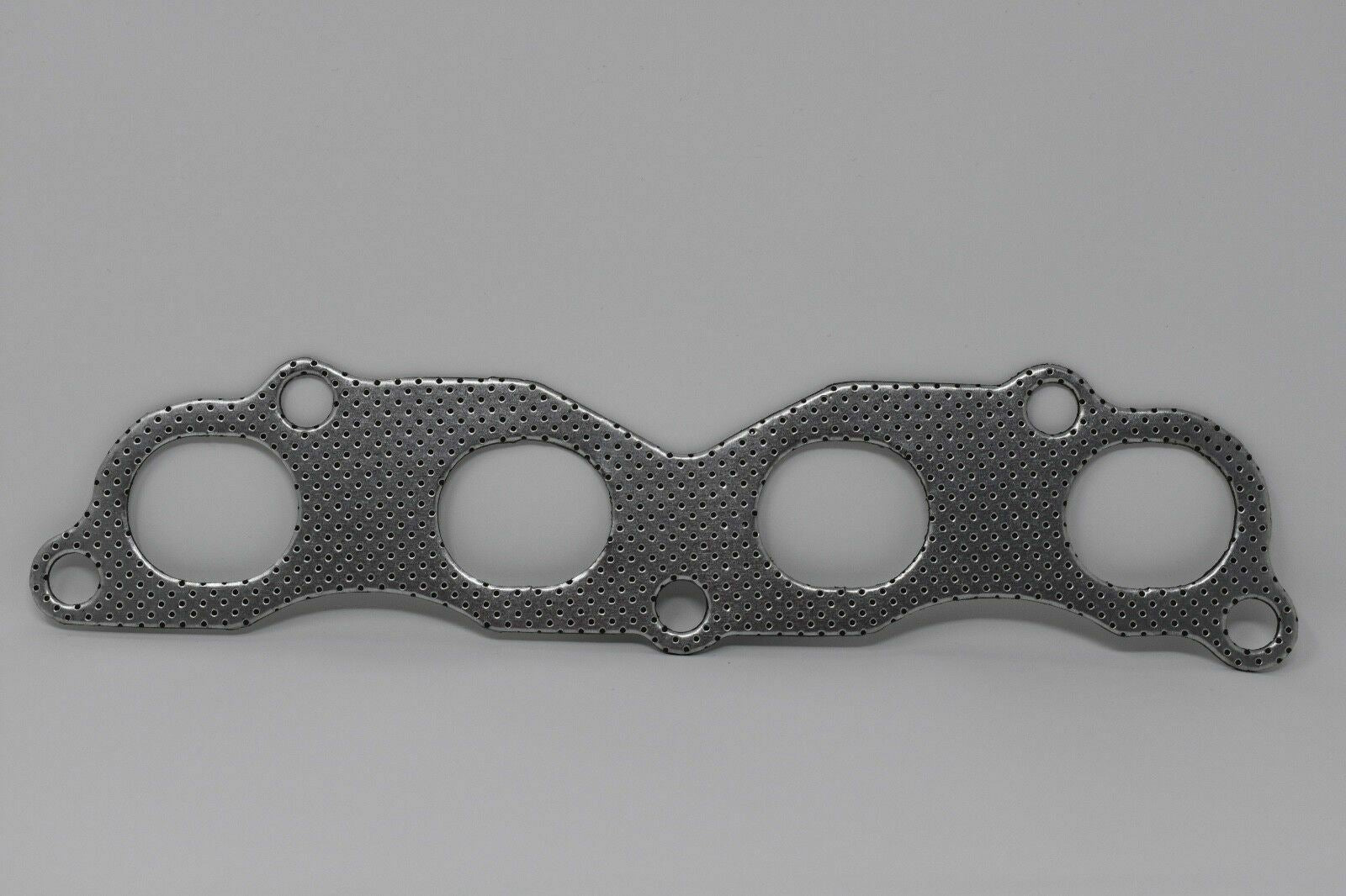 Jack Spania Racing graphite exhaust manifold gasket for Acura Honda K20 K24 K series engine, suitable for EP3 Type S, TL, TSX models.