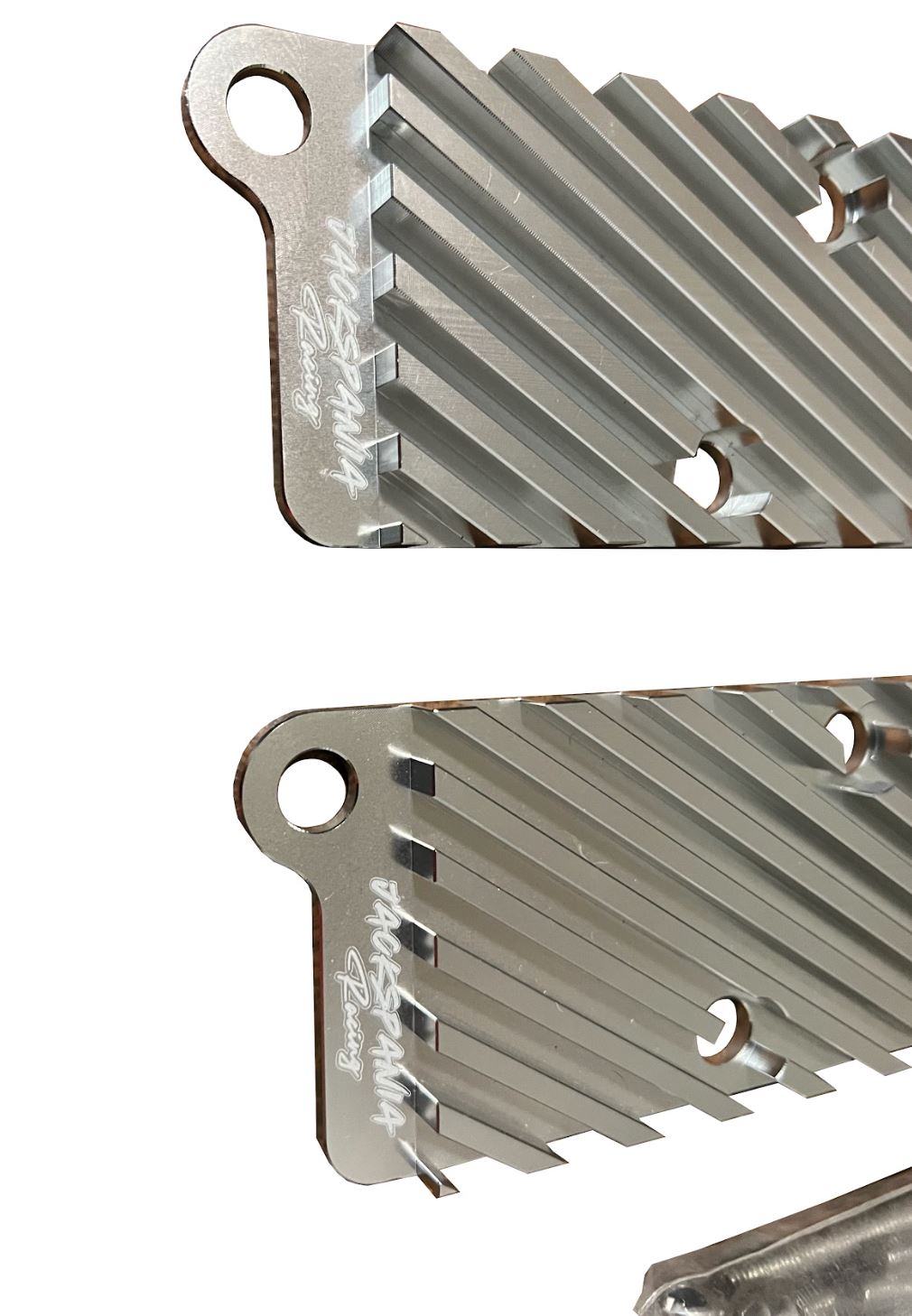 Jack Spania Racing 2.7T conversion coil pack hold-down bracket kit for Audi engine parts, shown mounted on engine.