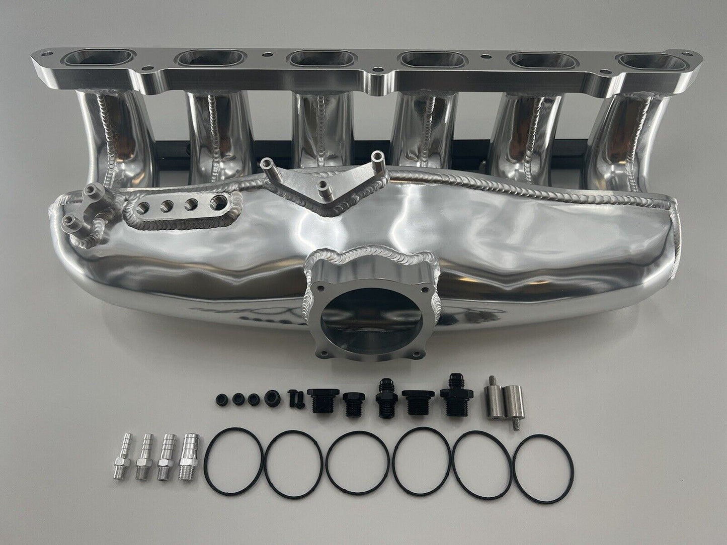 Center feed intake manifold fuel rail for BMW N54 135i, 335i, 535i E90 engine, by Jack Spania Racing, with visible metal components.