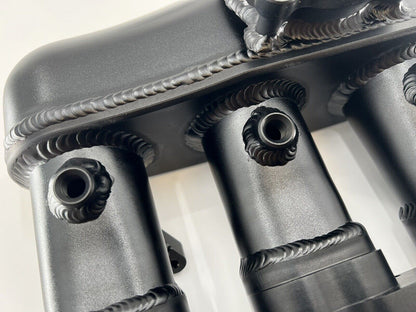 Engine intake manifold for VW Audi EA888 Gen 3 1.8T 2.0T by Jack Spania Racing, showing the metal construction and connection points.