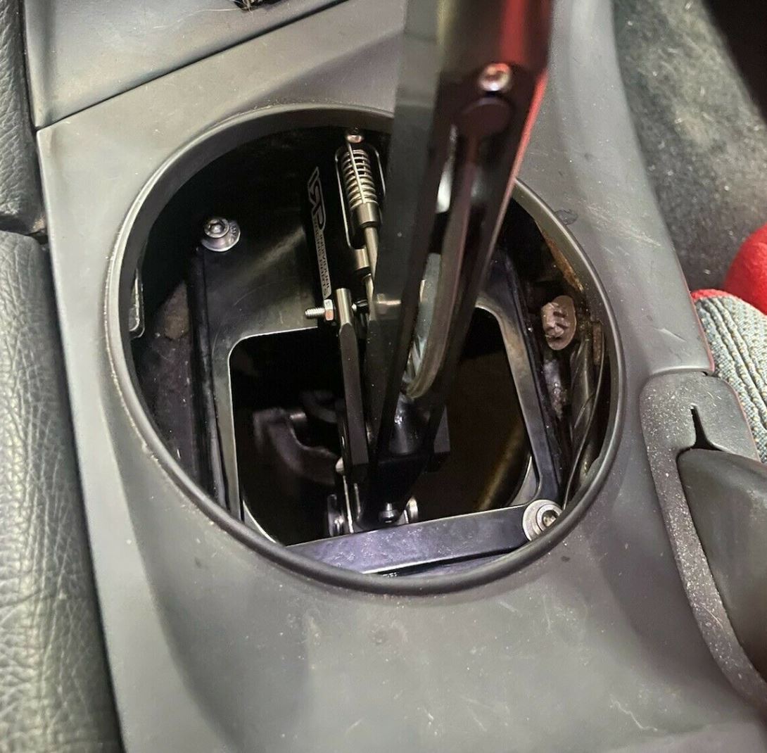 Jack Spania Racing MK4 Supra 2JZ GTE billet short shifter box with lockout for Toyota A80 transmission, featuring tripod design.