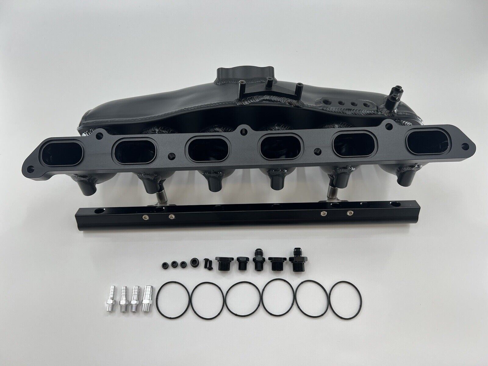 Center feed intake manifold fuel rail for BMW N54 135i, 335i, 535i engine parts by Jack Spania Racing, shown on engine.