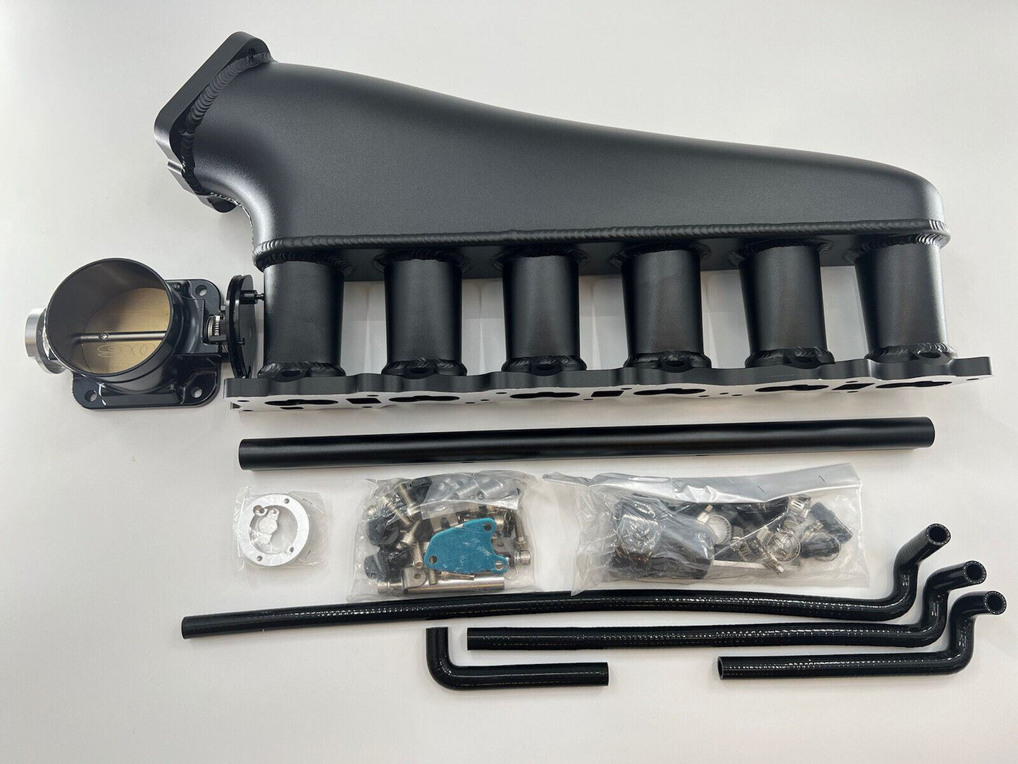 Jack Spania Racing RB20DET intake manifold, fuel rail, and 90mm GTR Skyline throttle body for engine swap installation.