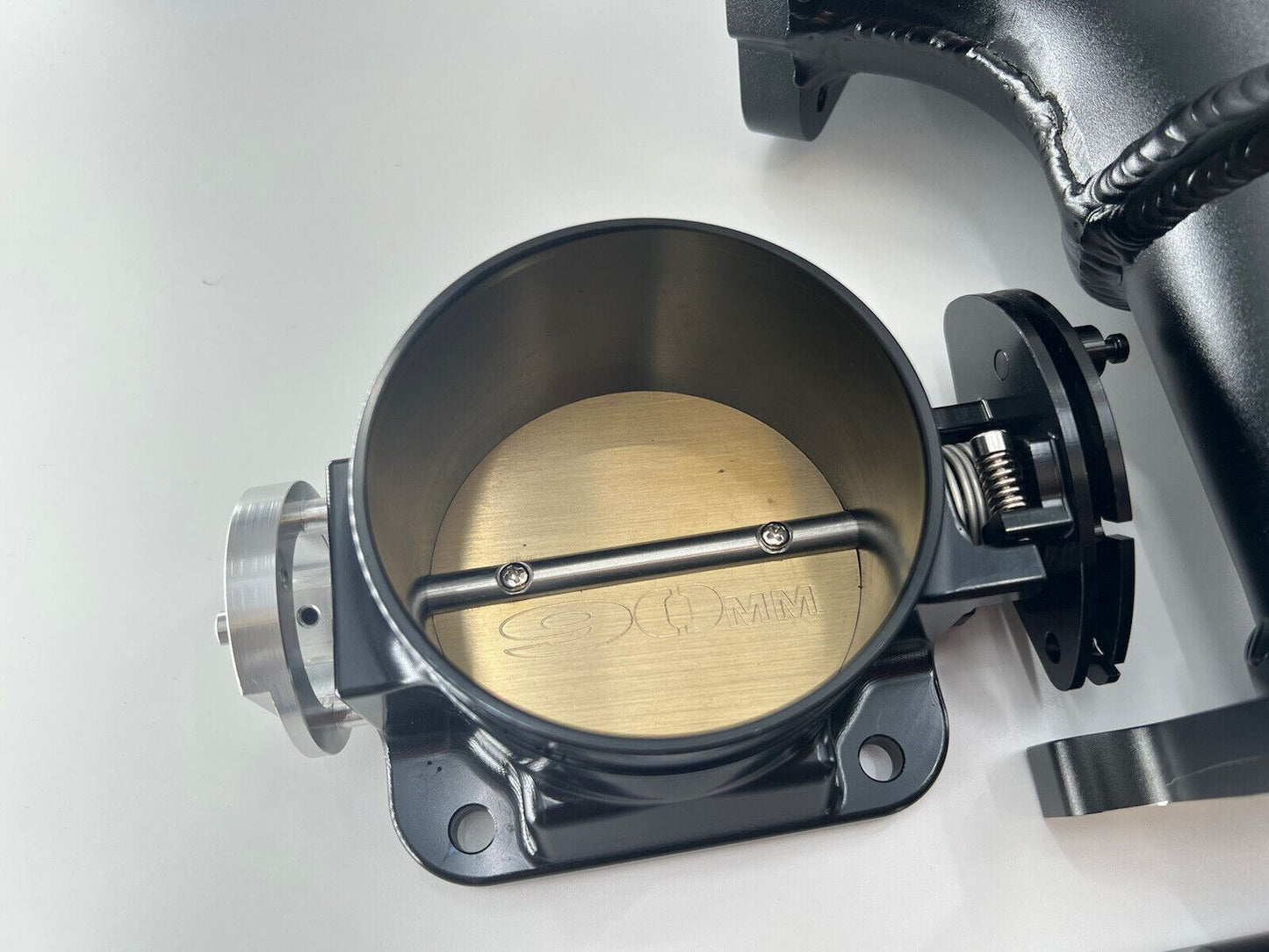 Jack Spania Racing RB20DET intake manifold with 90mm throttle body and fuel rail for Nissan Skyline GTR engine swap.