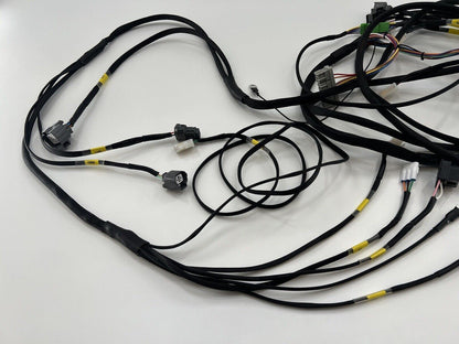 Honda Acura EG 92-95 front headlight wire tuck harness by Jack Spania Racing, shown with engine parts and blinker components.