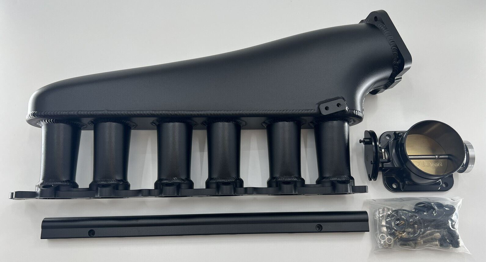 Jack Spania Racing 1JZ GTE billet intake manifold with fuel rail and 90mm throttle body for engine performance.