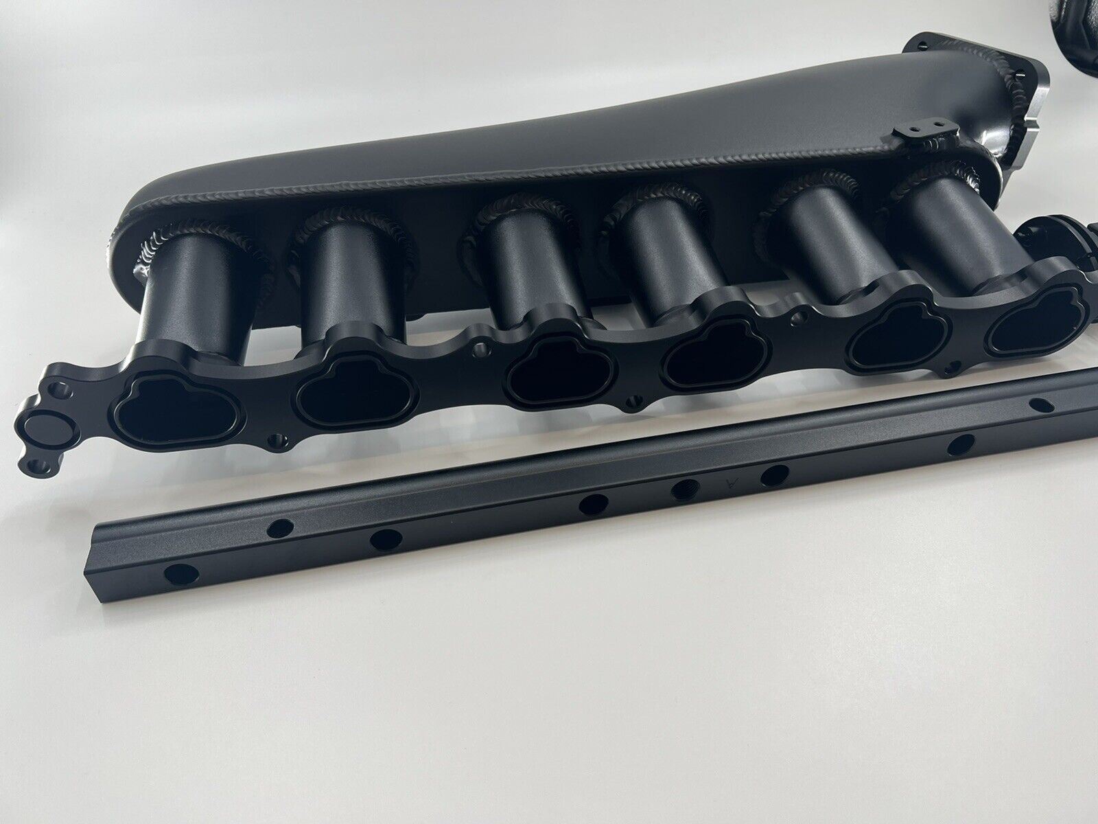 Jack Spania Racing 1JZ GTE billet intake manifold with fuel rail and 90mm throttle body for engine performance.