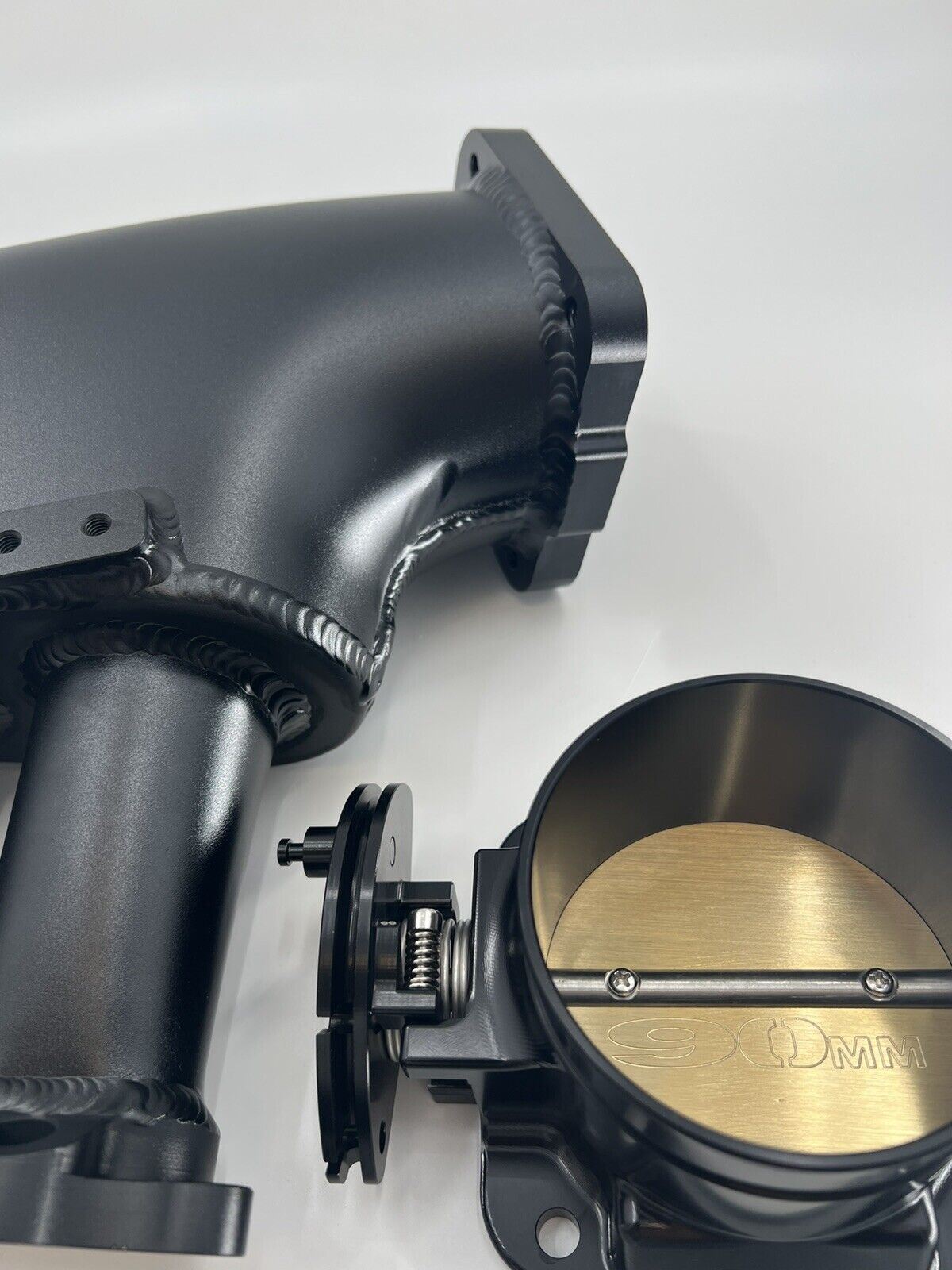 Jack Spania Racing 1JZ GTE billet intake manifold with fuel rail and 90mm throttle body for engine performance.