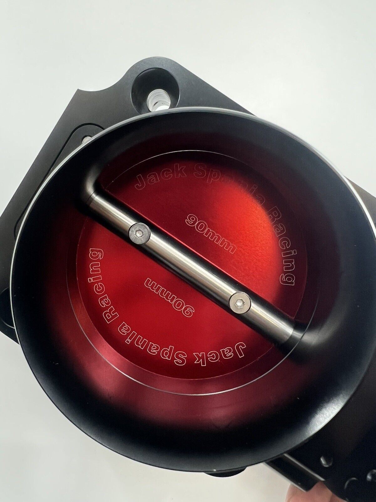 Jack Spania Racing 90mm throttle body with 4-inch hose coupling adapter for engine intake systems, shown with inlet and connectors.