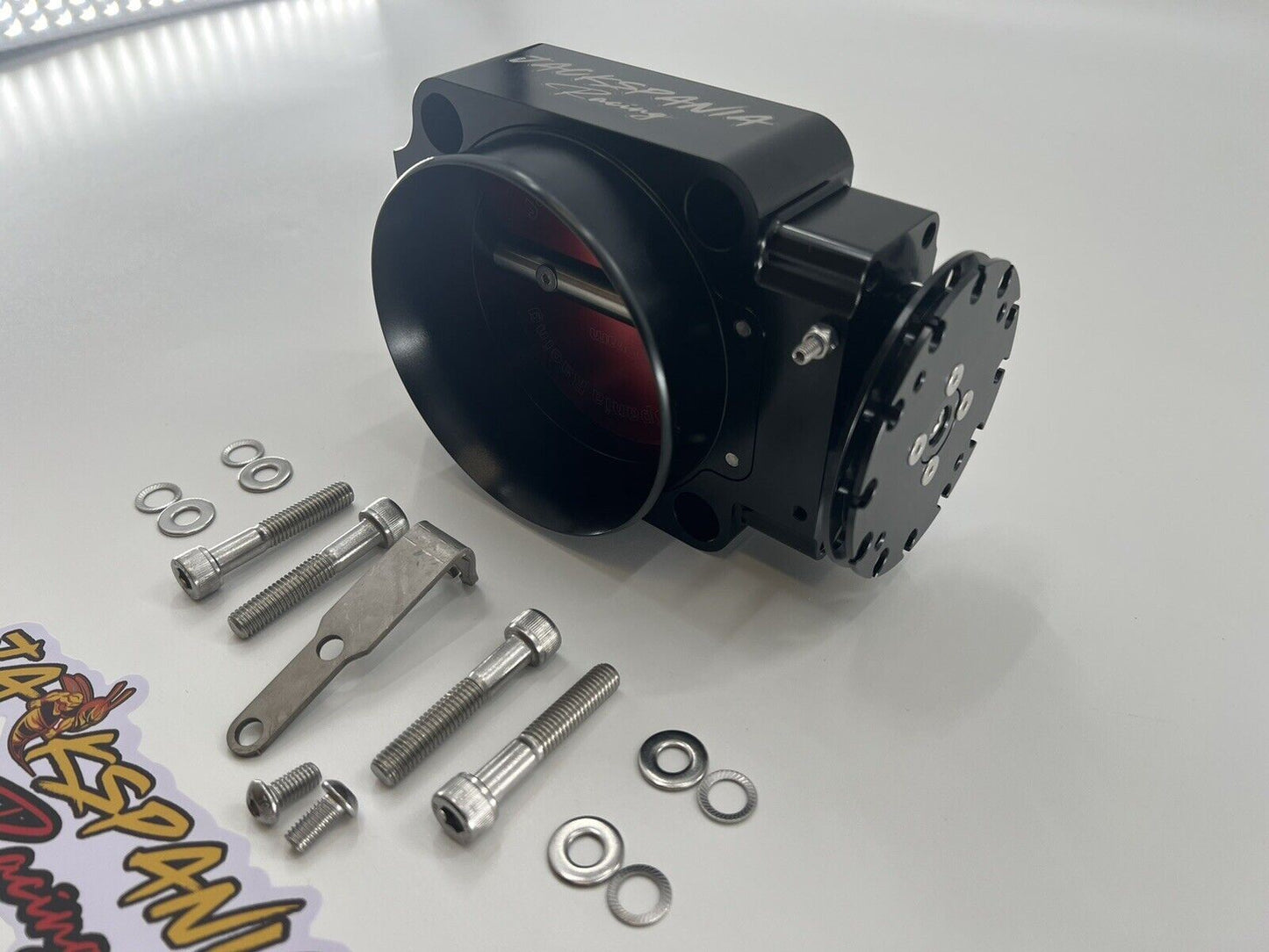 Jack Spania Racing 90mm throttle body with 4-inch hose coupling and inlet for engine performance applications.