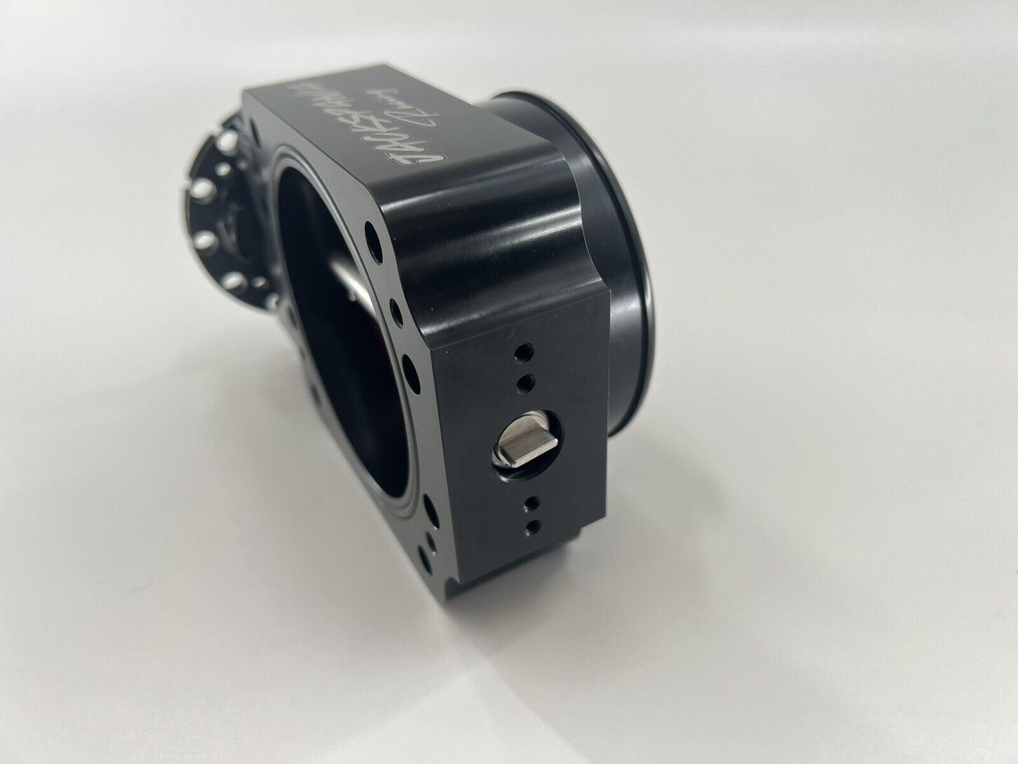 Jack Spania Racing 90mm throttle body with 4-inch hose coupling adapter installed on engine part.