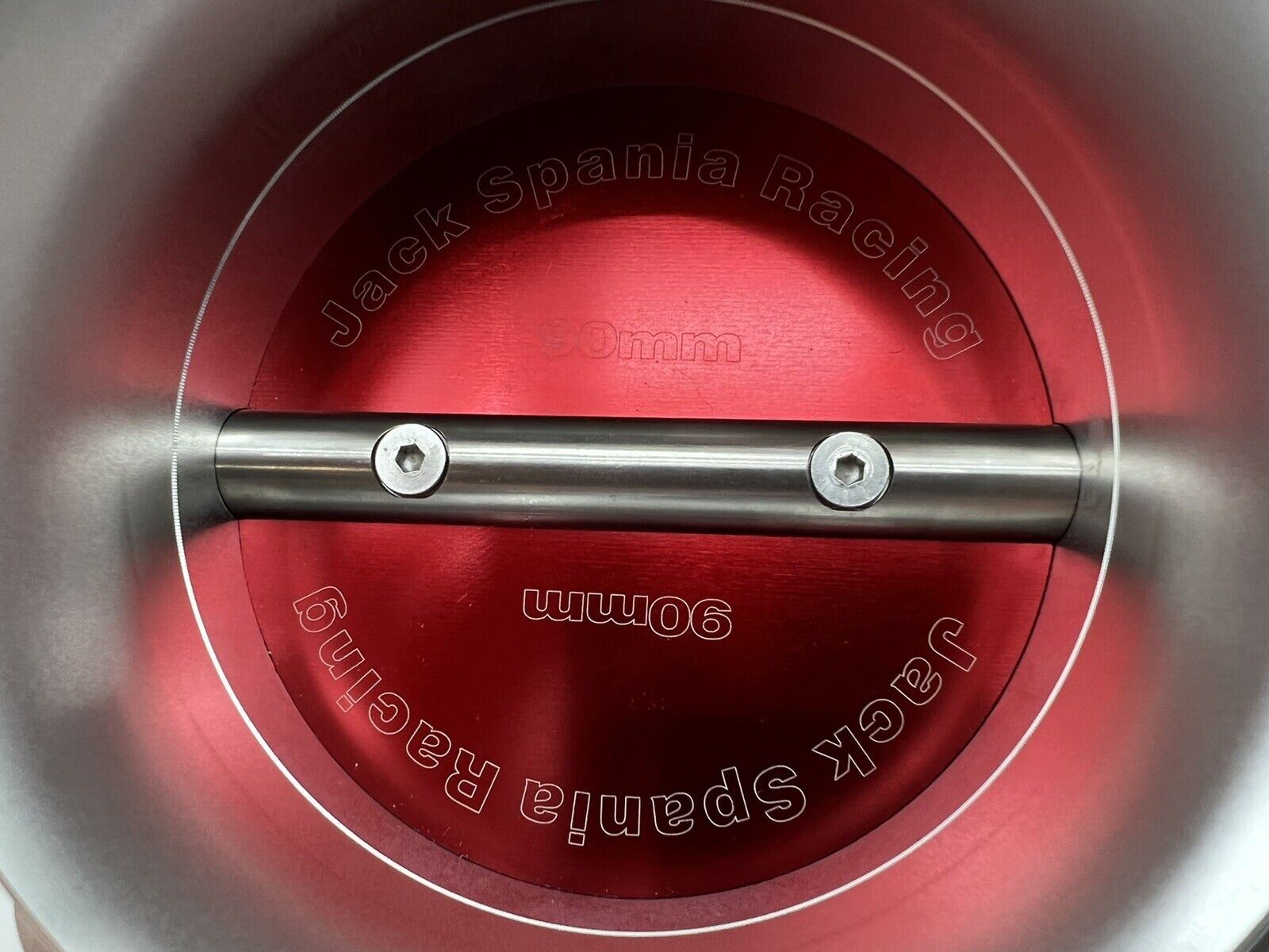 Jack Spania Racing 90mm throttle body with 4-inch hose coupling adapter for engine intake, shown with inlet and connecting parts.