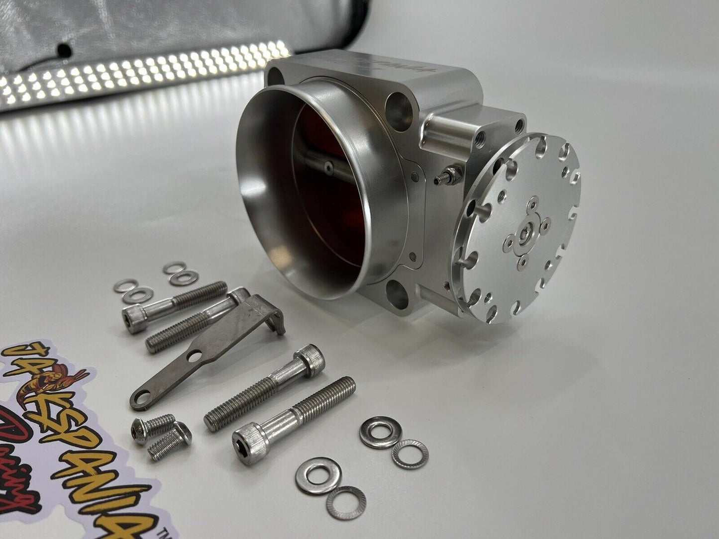 Jack Spania Racing 90mm throttle body with 4-inch hose coupling adapter for engine inlet, automotive performance part.