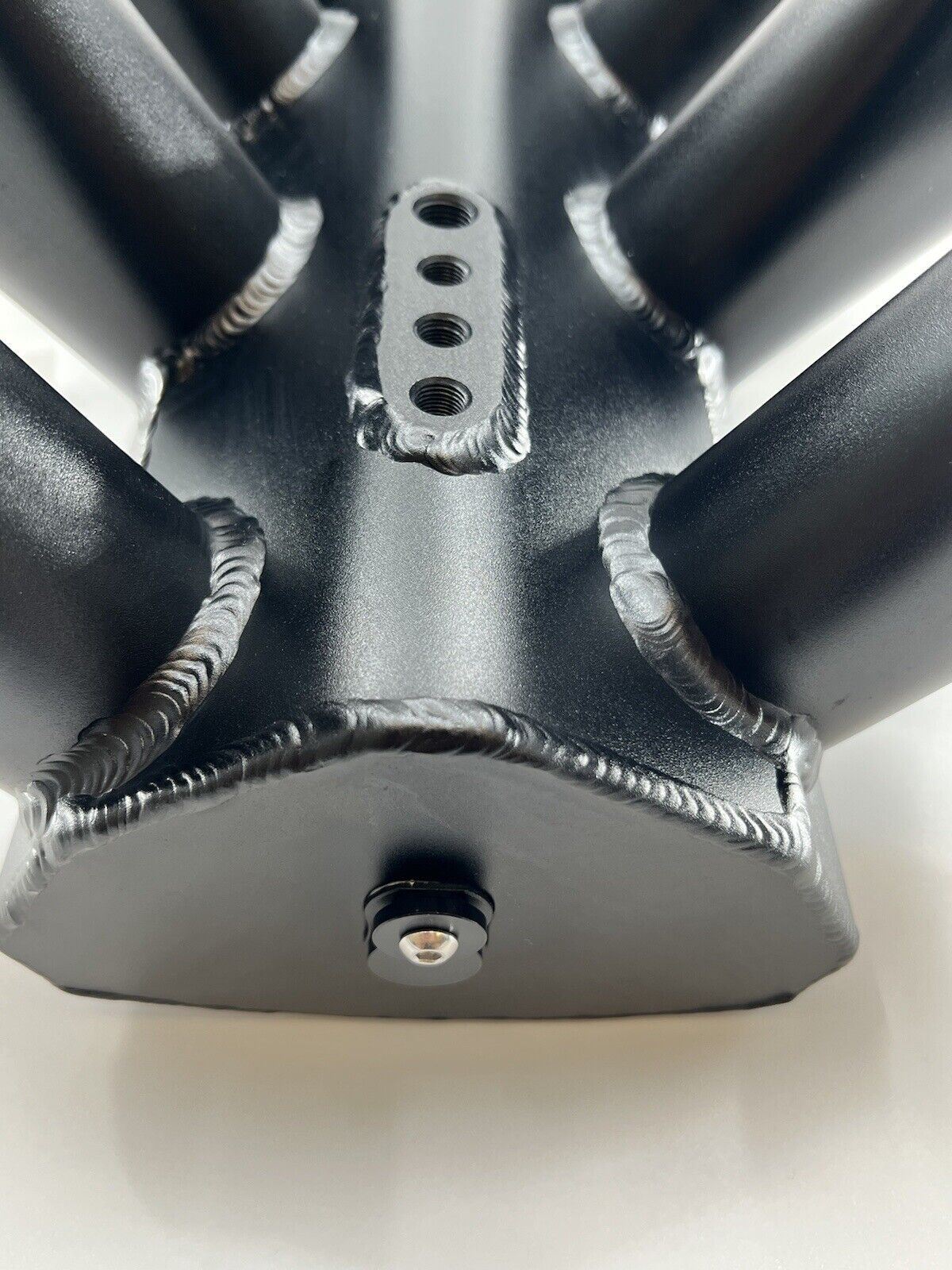 GM Chevrolet LS fabricated intake manifold throttle body for LS3 L92 engines by Jack Spania Racing, showing the engine component.