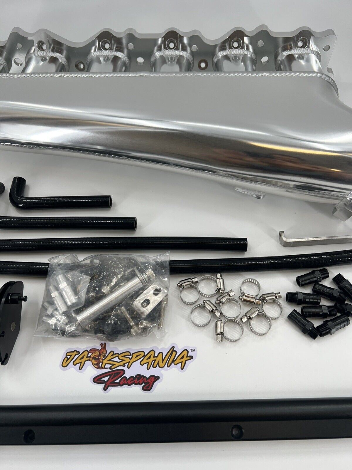 Jack Spania Racing RB25DET intake manifold, fuel rail, and 90mm throttle body for Nissan Skyline engine upgrade.