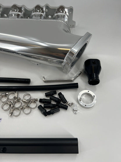 Jack Spania Racing RB25 RB25DET intake manifold fuel rail and 90mm Skyline throttle body for engine performance.