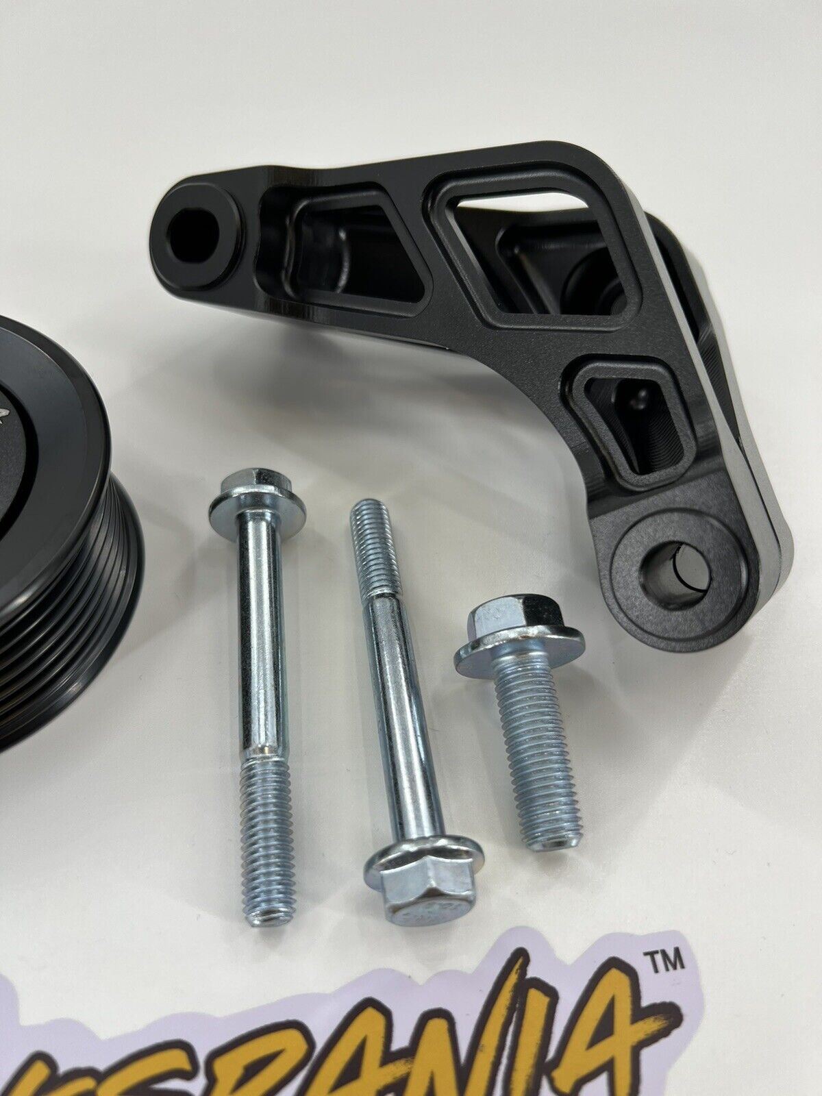 Jack Spania Racing K Series Idler Bracket Kit for K24A engine, includes power steering pump removal, pulley, and tensioner components.