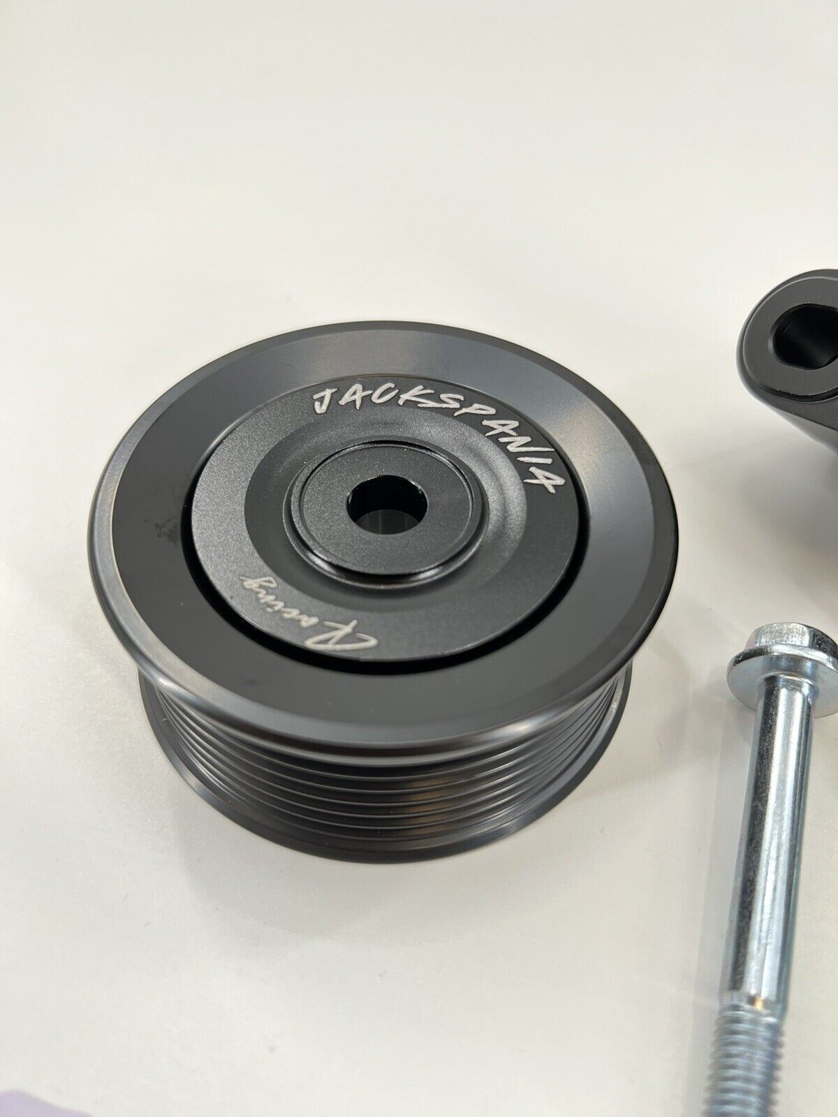 Jack Spania Racing K Series Idler Bracket Kit with pulley tensioner for K24A engine, includes power steering pump removal components.