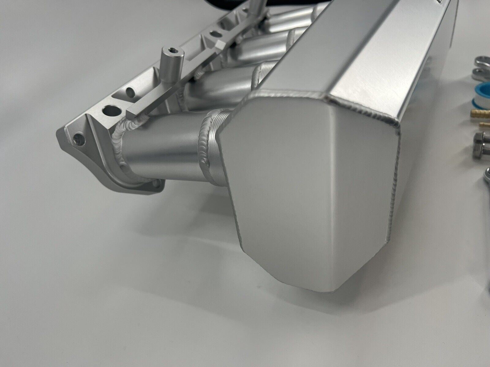 Jack Spania Racing 90mm Ultra Side Feed Intake Manifold for K Series K20 K24 engines on a car engine plenum.