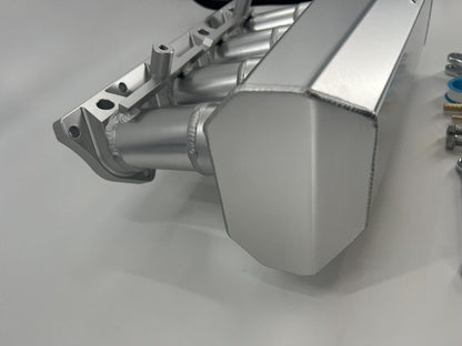 Jack Spania Racing 90mm Ultra Side Feed Intake Manifold for K Series K20 K24 engines on a car engine plenum.