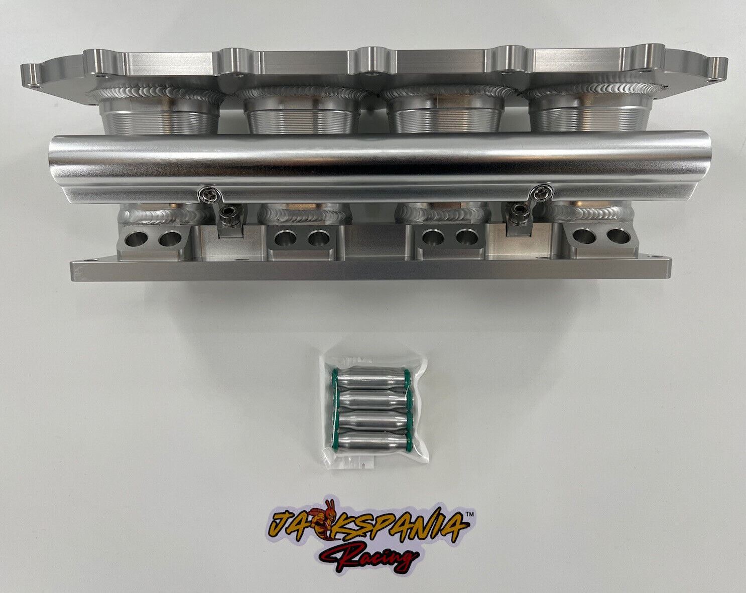 Jack Spania Racing billet K series intake manifold adapter for Skunk2 Ultra engine parts, showing the precision-machined metal component.