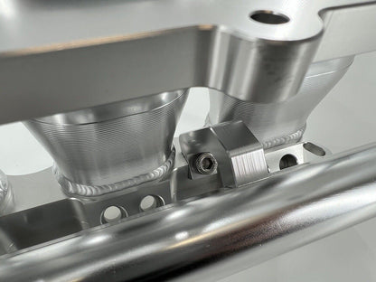 Jack Spania Racing billet K series intake manifold adapter for Skunk2 Ultra engine parts, displayed on a clean surface.