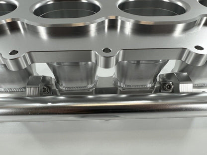 Jack Spania Racing billet K Series intake manifold adapter for Skunk2 Ultra engine parts, shown on a clean engine component.