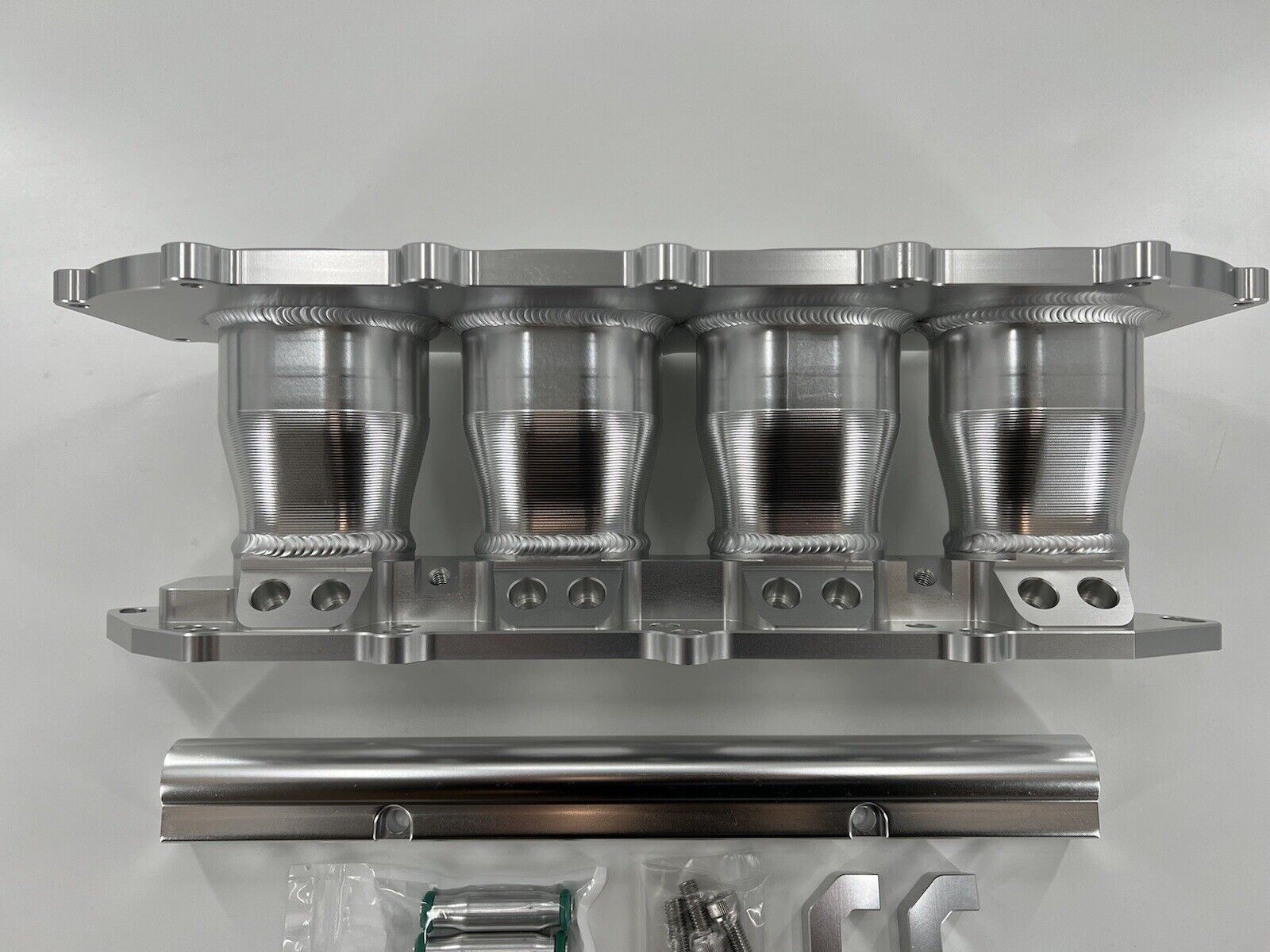 Jack Spania Racing billet B Series intake manifold adapter kit for Skunk2 Ultra Plenum engine parts shown in image.